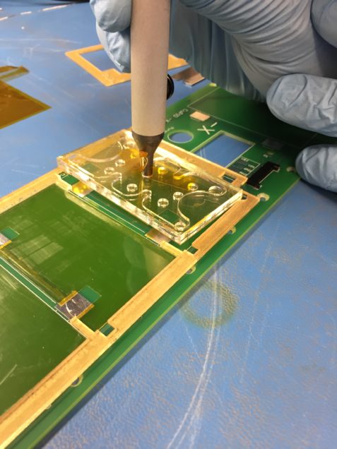 An assembly of acrylic layers was made to attach to the end vacuum tool such that the double sided Kapton could be properly held as it was laid onto the printed circuit board. 