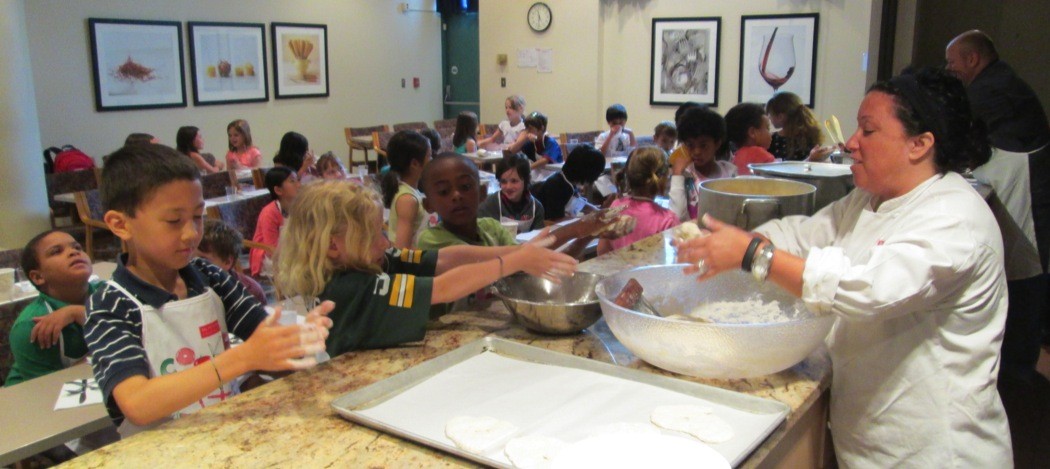Lisa Falso shows students how to shape dough for sweet fry-bread.