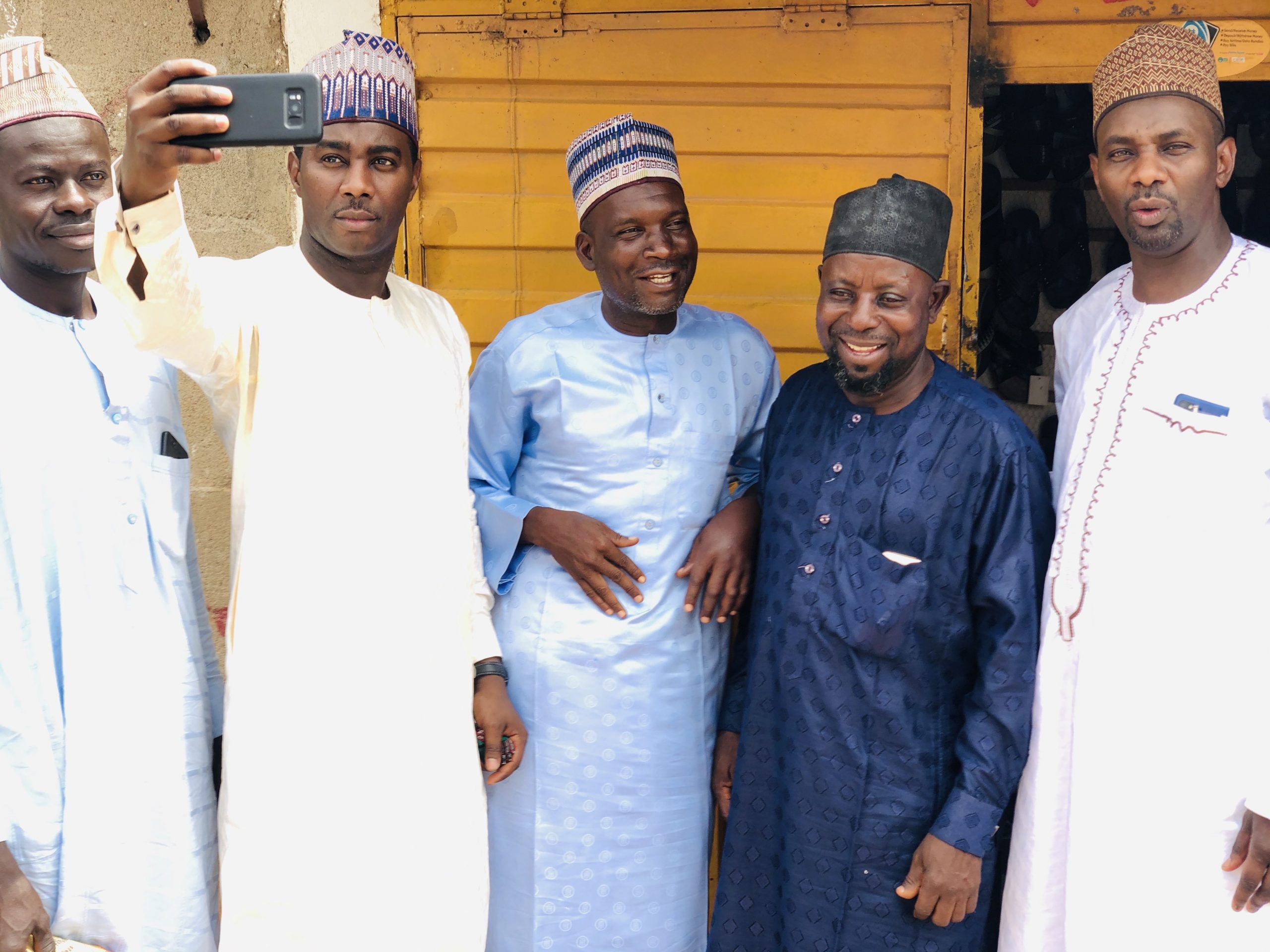 Dr. Mustapha H. Kurfi (on the right) with friends and siblings, and a groom taking a selfie.