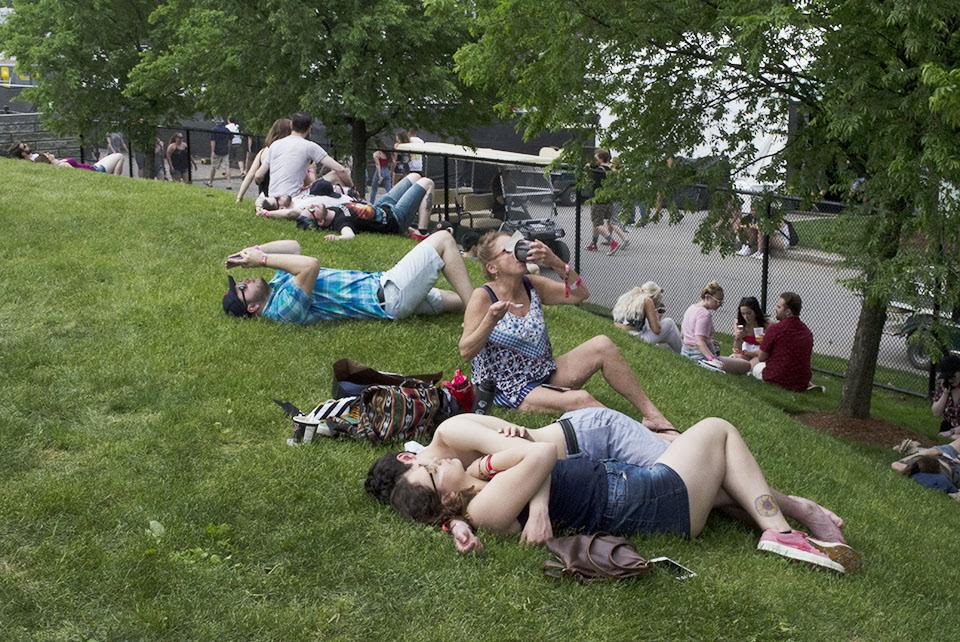 Festival attendees rested on the grass in the Harvard Athletic Complex on the second day of Boston Calling on May 26, 2018. Photo by Miranda Suarez / WTBU