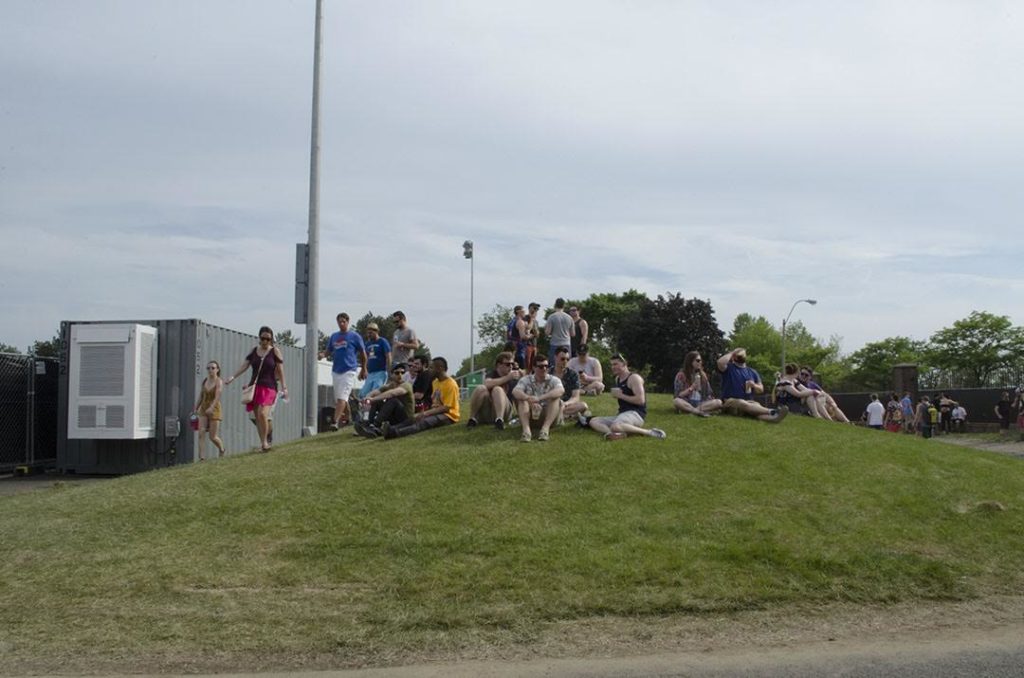 Attendees of the Boston Calling Music Festival resting on a hill on May 26, 2018. Photo by Miranda Suarez / WTBU.