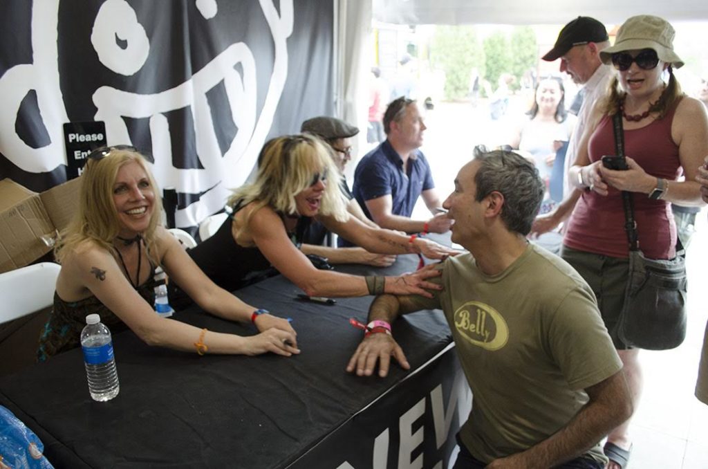 The band Belly laughs with a fan during a signing at the Boston Calling Music Festival on May 26, 2018. Photo by Miranda Suarez / WTBU.