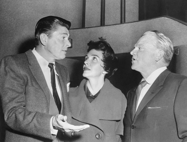 Man at left (Ronald Reagan) talks to a woman, center (Mrs. Reagan) and man at right (James Cagney).