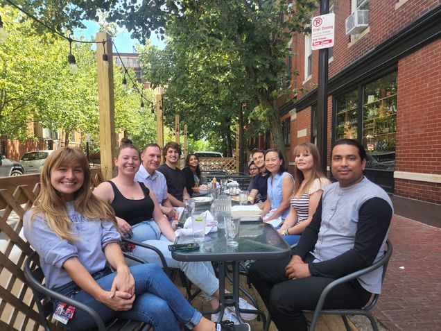 Image showing Bosmann Lab members around an outside table at El Centro, Boston