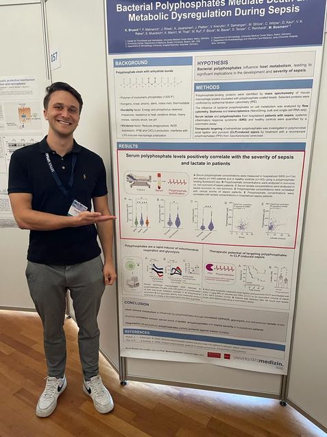 Photo of Kevin presenting a poster