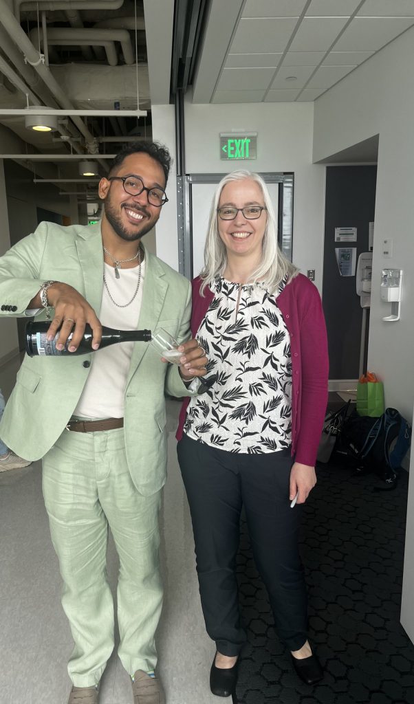 Dr. Schon and Michael Rosario celebrating after dissertation defense