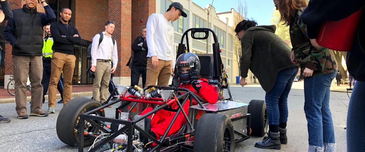 Test drive on cummington mall with people observing the car