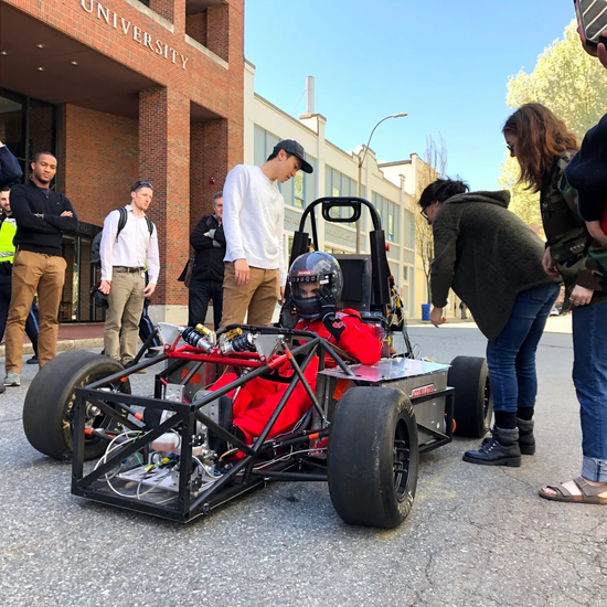Test drive on cummington mall with people observing the car