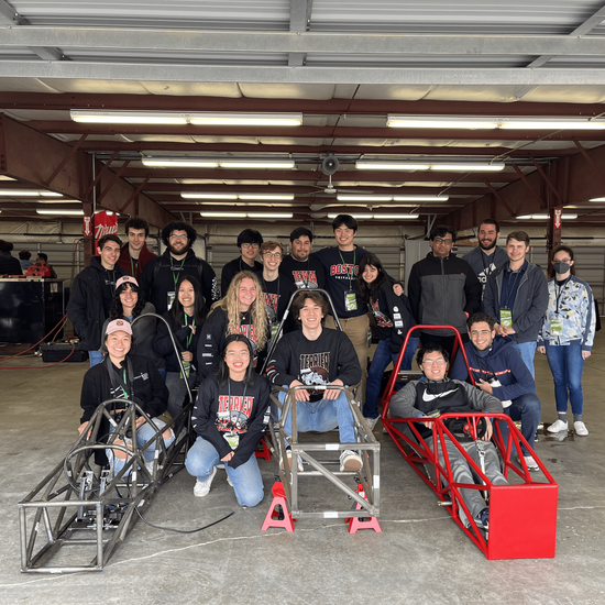 Members sitting in chassis at competition