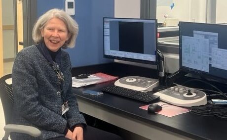 Dean sitting in front of the microscope computer preparing for the first light