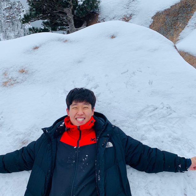 HyunJoon Kim lying in the snow