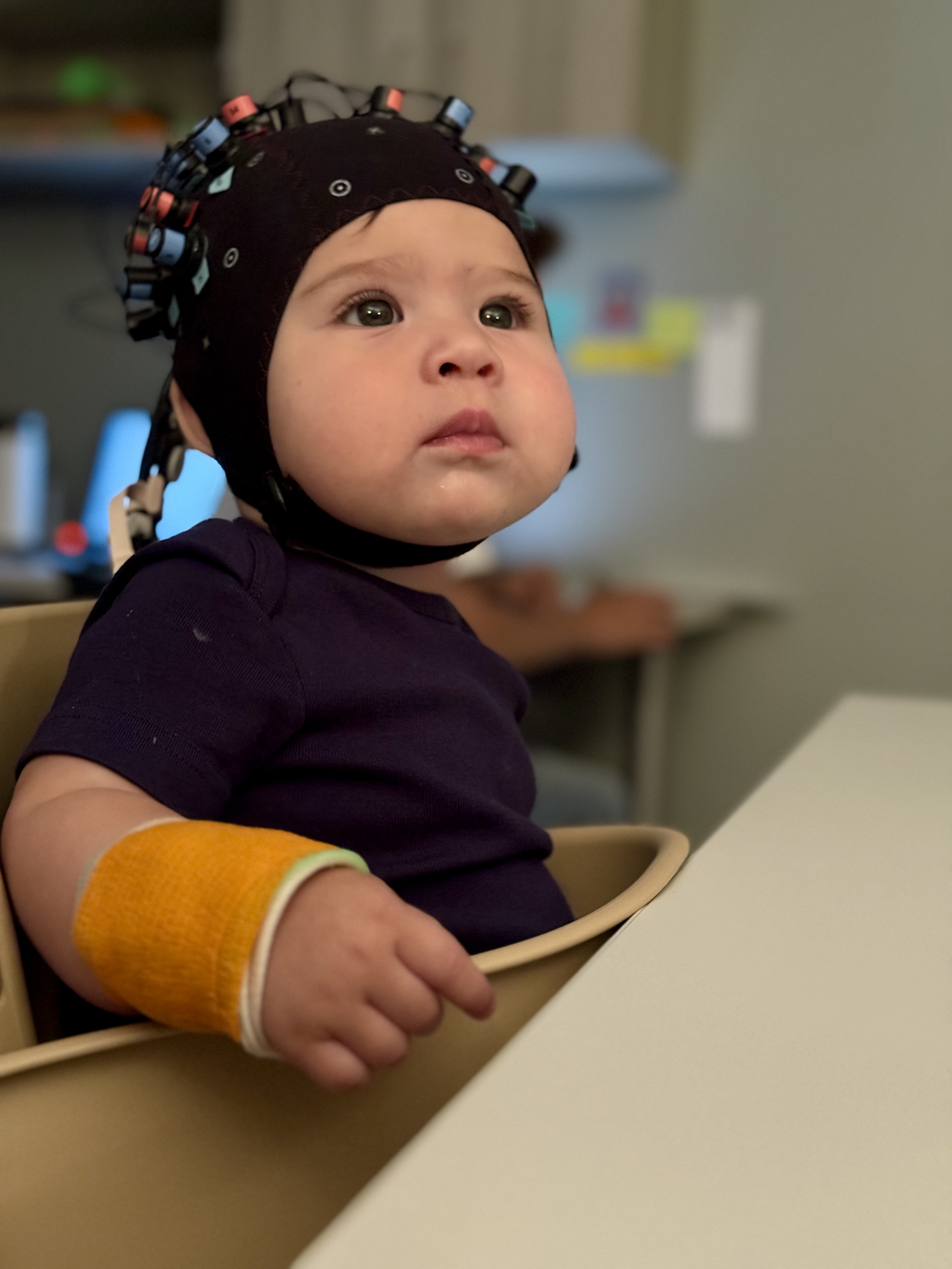 Infant wearing fNIRS cap in DEMR Lab
