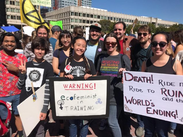 Members of the FEJ Program community pose with protest signs at the climate strike.