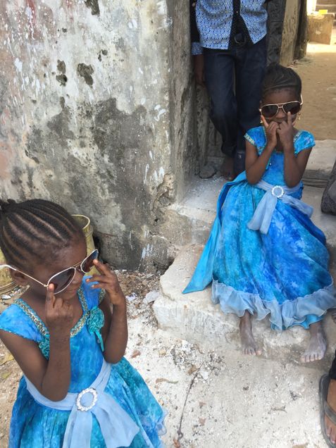 Maya's neighbors try on her glasses.