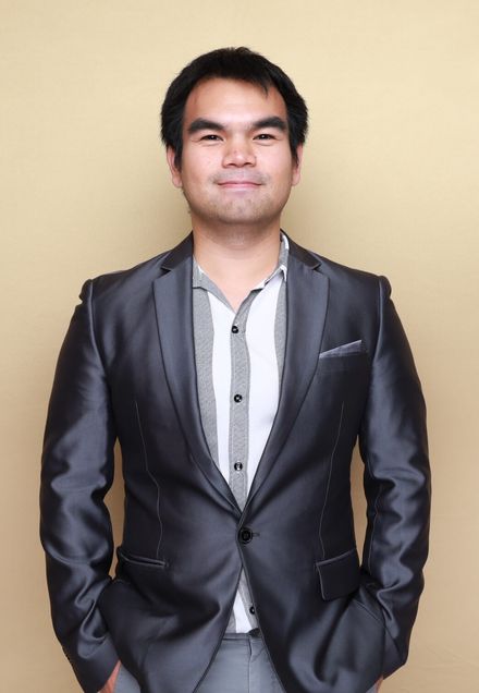 Man standing in center of photo in suit