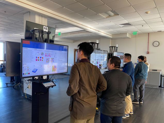 the dries lab read their evans day posters which are presented on screens, with their backs facing the camera