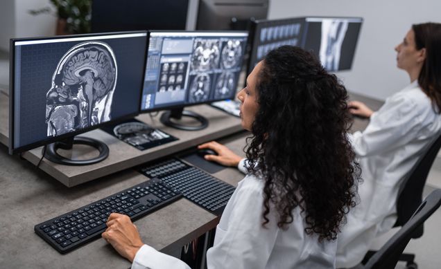 Doctors working with computer and analyzing medical scans