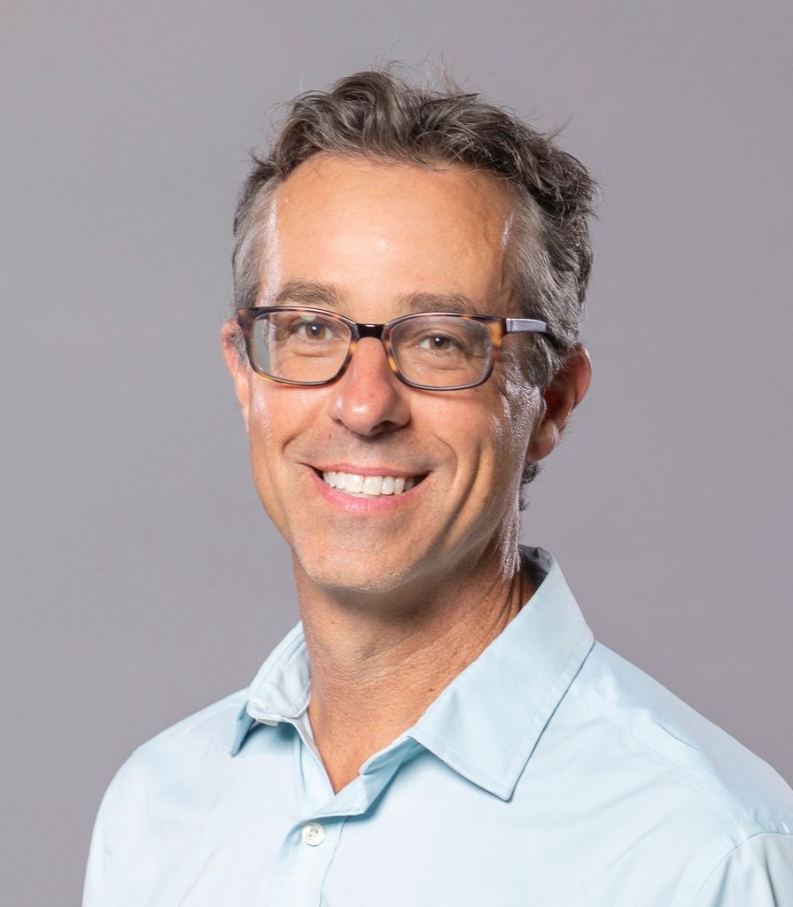 Eric Gordon smiling portrait.