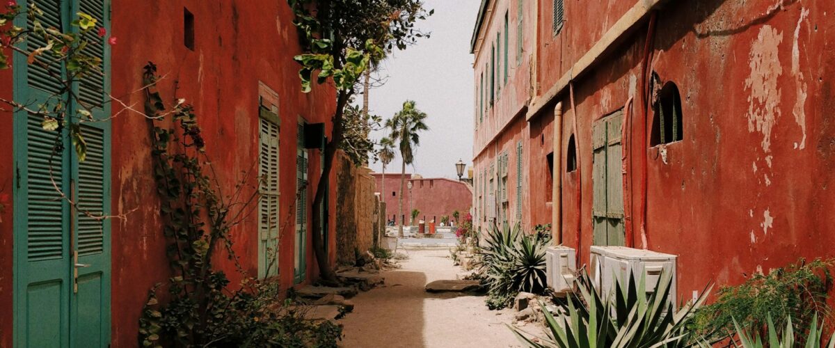 Red Houses in Dakar, Photo by Anton Lecock on Unsplash