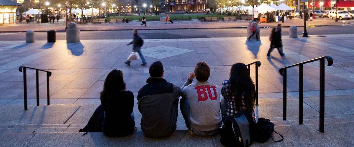 Four Boston University students sit together in Copley Square