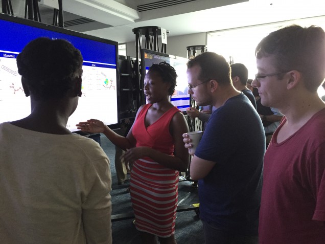 De'Ja explains her research to another participant and to graduate student mentor, Nathan Frey 