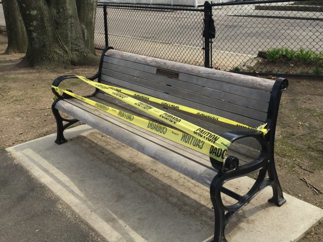 Park bench with caution tape